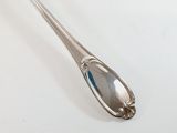 a spoon that is sitting on a white surface