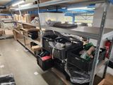 many boxes and bins on the shelves in the warehouse