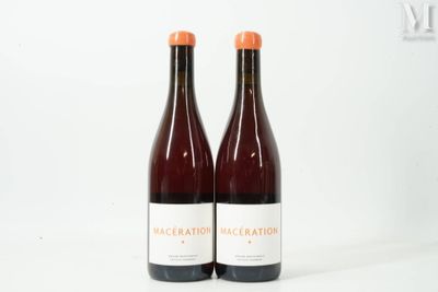 two bottles of wine sitting next to each other on a white surface