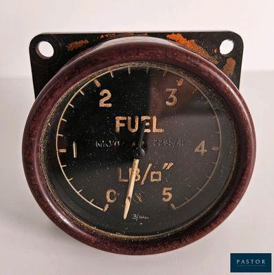 a close up of a clock on a white surface
