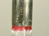 a glass bottle with a red liquid inside of it