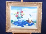 a picture of a painting of flowers in a vase on a easel