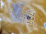 a close up of a brown vase with a spider on it
