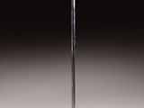 a silver floor lamp with a glass shade on it