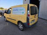 yellow van parked in a parking lot with other cars in the background