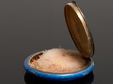 a small blue bowl with some sugar inside of it