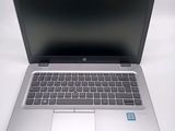 a laptop computer sitting on a white surface