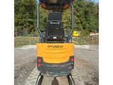 the back end of a small construction vehicle parked in a parking lot