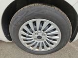 a close up of a tire on a white car