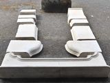 a white couch sitting on the ground next to a fire hydrant