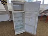 a white refrigerator with its door open in a room