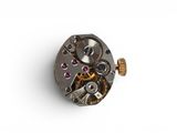 an image of a close up of a watch movement on a white surface