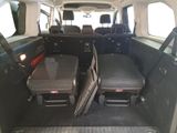 the back of a van with luggage in the back of it