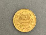a close up of a gold coin on a gray surface