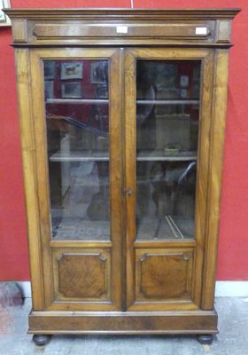 a large wooden cabinet with glass doors on it