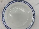 a white plate with a blue rim on a table