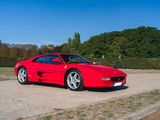 a red sports car parked on the side of the road