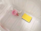 a yellow piece of paper in a plastic container