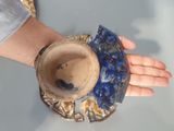 a person that is holding a bowl in their hand