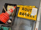 a yellow sign that says route barrle next to a traffic cone