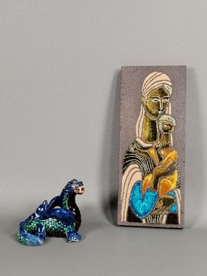 two figurines sitting next to each other on a table