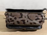 a small purse with a leopard print pattern on it