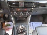 the interior of a car with a steering control and dashboard controls