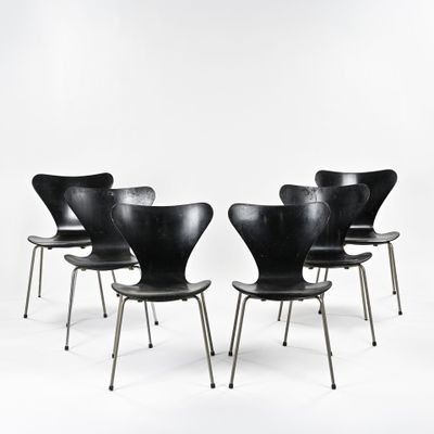 six chaises noires aux pieds métalliques sur fond blanc