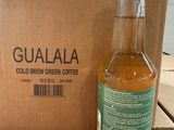 a bottle of cold brew sitting next to a cardboard box