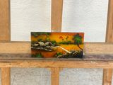 a picture of a small clock on a wooden bench