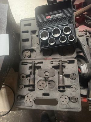 a tool box with tools on a table next to a laptop