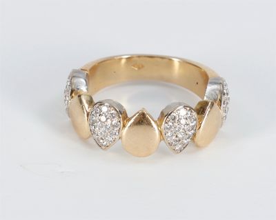 a close up of a gold and diamond ring on a white surface