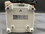 a close up of a white box with a power cord on it