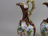 two vases that have been painted with flowers on them