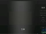 the black microwave oven has a digital display on the door