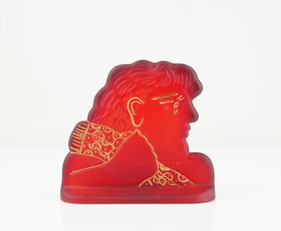 a red statue of a man with a crown on it ' s head