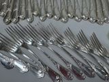 a lot of forks and spoons that are on the table
