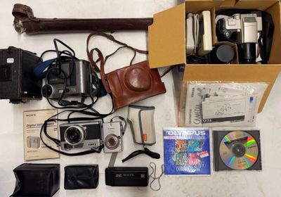 a box full of cameras and other items on a table