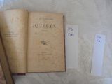 two old books on a table with a price tag