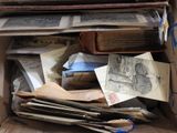 a cardboard box full of old papers and books