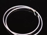 a close up of a silver bracelet on a black surface