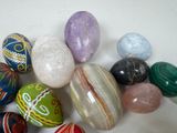 a lot of different colored marbles on a white surface