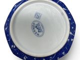 blue and white porcelain bowl with a blue rim on a white surface