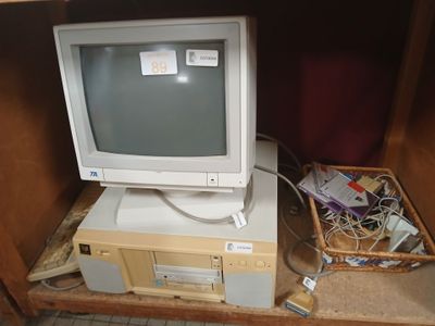 a computer monitor sitting on top of a computer desk