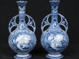 pair of blue and white vases with figures in a landscape