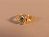une bague en or sertie d'une pierre verte et de diamants