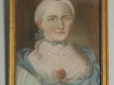 portrait of a woman in a blue dress with a flower in her hair