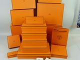 an image of a pile of orange boxes sitting on top of a white table