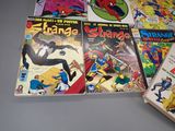 a lot of comic books sitting on a table