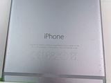 a silver iphone sitting on top of a white box